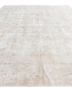 an antique rug is shown on a white background, with faded edges and floral designs