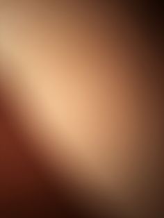 a blurry image of an orange and brown background