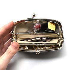 The origin of the name "gama-guchi" comes from the fact that it resembles a toad with a big mouth. "Gama" means toad, and "guchi" means mouth in Japanese. Gamaguch is a coin purse with a metal clap. Although it is often considered to be a traditional Japanese wallet, gamaguchi came to Japan from Europe in the Meiji era. The wide opening like the mouth of a toad makes the purse extremely practical. This beautiful gamaguchi is hand-crafted in Japan. Size: 14 (W) x 3 (D) x 10.5 (H) cm Material: Lea Gamaguchi Purse, Organizing Jewelry, Storing Jewelry, Inside My Bag, What In My Bag, Portable Storage, New Energy, Stay Organized, Traditional Japanese