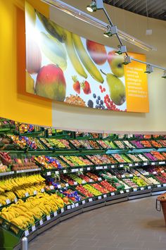 a produce section in a grocery store filled with lots of fresh fruits and veggies