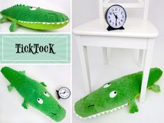 there is a stuffed alligator next to a clock