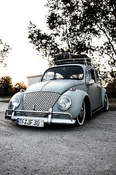 an old car with a surfboard on the roof