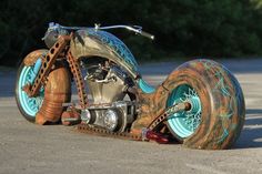 an old motorcycle is sitting on the ground with chains attached to it's wheels