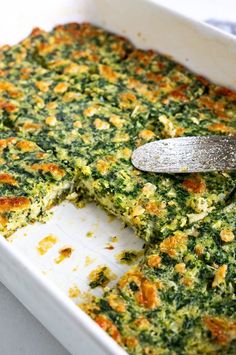 a casserole dish with spinach and cheese in it, ready to be eaten