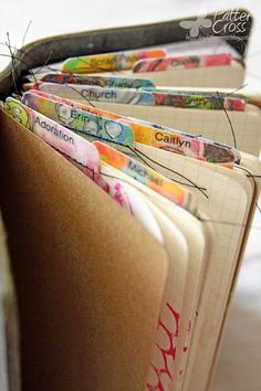 a close up of an open book with many different colored papers on it and the word faith written in cursive writing