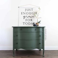 a green dresser with flowers on top and a sign above it that says just enough grace for today