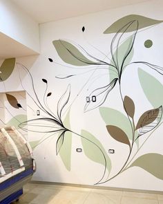 an artisticly designed wall with leaves painted on it