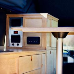 a kitchen with an oven, microwave and cabinets in the back ground side by side