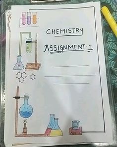 a clipboard with some writing on it and science related items in the back ground