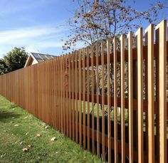 a wooden fence in front of a house