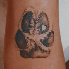 a cat paw with a heart tattoo on it