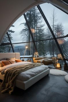 a large bed sitting inside of a bedroom on top of a floor next to a window