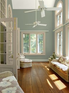 a living room filled with furniture and lots of windows