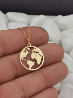 "14k Solid Gold Earth Necklace, World Map medallion Necklace, Gold Coin Globe Necklace, Gold Disc WanderLust Necklace, Globetrotter You Can Choose The Size Of the Pendant Using The 2nd Option Box The Size in the Photos is for 0.75inches (19.1mm) Both Pendant and Chain are 14k Solid Gold ♥ Material of pendant and chain: Solid Gold k14 ♥ Packaging: All of our jewelry is beautifully boxed and ready for gifting For more personalized designs take a look here: ♥ www.etsy.com/listing/631444472 ♥ www.et Gold Medallion Jewelry For Travel, Gold Round Pendant Necklace For Travel, Gold Necklace With Round Pendant For Travel, Gold Engraved Jewelry For Travel, Travel Engraved Gold Jewelry, Earth Necklace, Wanderlust Necklace, Globe Necklace, World Map Necklace