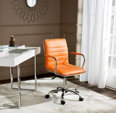 an orange leather office chair sitting in front of a white desk with a clock on it