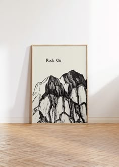 a black and white poster with the words rock on in front of a wooden floor