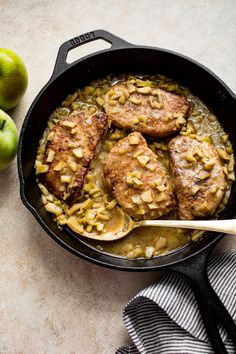 pork chops and apples are in a skillet