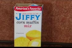 a carton of corn muffins sitting on top of a counter next to a wall