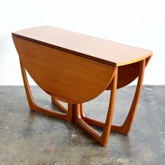 a wooden table sitting on top of a cement floor