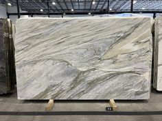 large marble slabs are on display in a warehouse