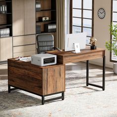 an office desk with a printer on it in front of a large window and bookshelf