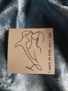 a piece of paper with a drawing of a man and woman kissing each other on it