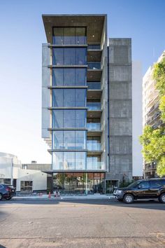 an apartment building with cars parked in front of it