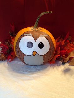 a pumpkin with an owl painted on it