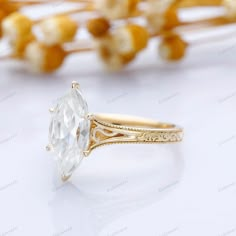 a yellow gold ring with an oval cut diamond