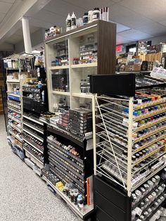 the shelves are full of various items in the store, including canned food and beverages