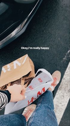 a person sitting on the ground with a paper bag over their head