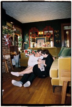 two people sitting on the floor in a living room