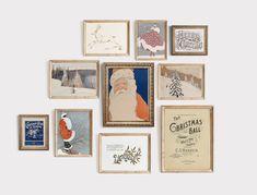 a collection of framed christmas cards with santa claus and other holiday greetings on the wall