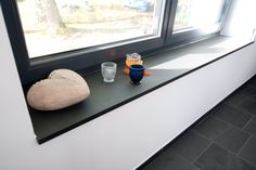 a window sill with some rocks and glasses on it