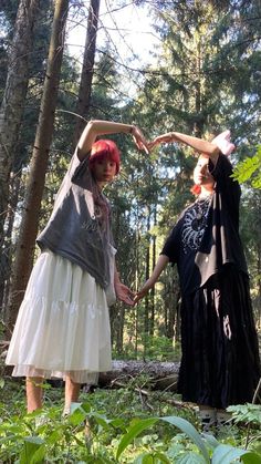 two women in the woods holding hands