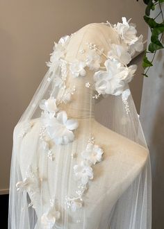 the veil is adorned with flowers and pearls