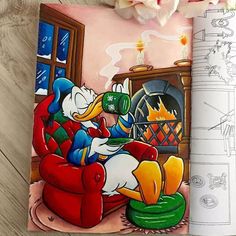 an open children's book with a drawing of donald duck on the cover and a fireplace in the background