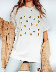 Matching sweatshirt: https://peachleafstore.etsy.com/listing/1046614652 ❀ Design is printed directly onto the t-shirt. ❀ More color options might be available upon request.  ❀ Size up if you want it oversized. ❀ The sizing is unisex. For garment measurements, please take a look at the size guide included in the listing images. Washing instructions to best preserve the print: ❀ Wash inside out using mild detergent, on a low temperature setting.  ❀ Let hang dry (do not tumble dry). Shop Homepage: Fun White T-shirt For Fall, White Custom Print Shirt For Fall, White T-shirt With Funny Print For Fall, Fun Custom Print Tops For Fall, Candy Corn Shirt, Corn Shirt, Halloween Shirts For Women, Last Minute Halloween Costume, Small Business Design