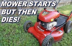 a lawn mower that is sitting in the grass