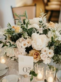 a table with flowers and candles on it