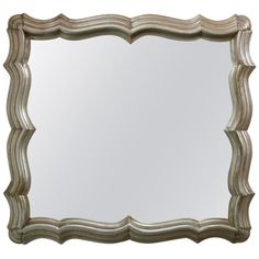 an ornate silver framed mirror on a white background