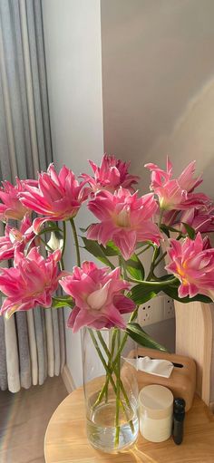 pink flowers are in a vase on a table