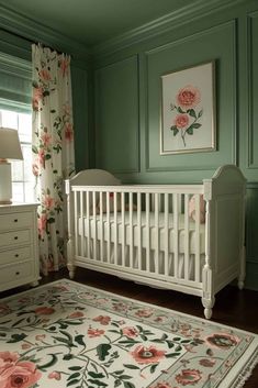 a baby's room with green walls and floral rug on the floor in front of a white crib