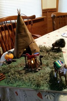 a table topped with fake animals and decorations