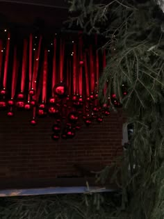 a christmas tree with red lights hanging from it's branches