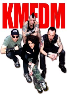 a group of people sitting next to each other in front of a red sign that says kmedm