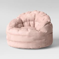 a round chair that is made out of pink velvet and has a circular seat on it