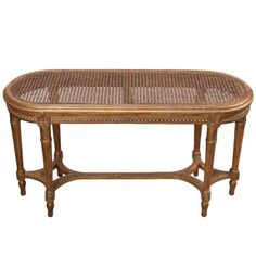 a wooden table with wicker top and legs