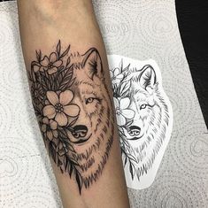 a woman's leg with a wolf and flowers tattoo on her left calf sleeve