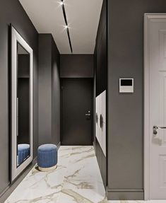 an empty hallway with grey walls and white doors